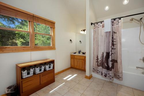 a bathroom with a shower and a sink at Blue Line Vista - Private Cabin Ellijay GA - Hot Tub, Game Room, Fire Pit, Private Balcony, Outdoor Dining - Ellijay, GA in Ellijay