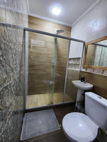a bathroom with a shower and a toilet and a sink at Maroca RIO in Rio de Janeiro