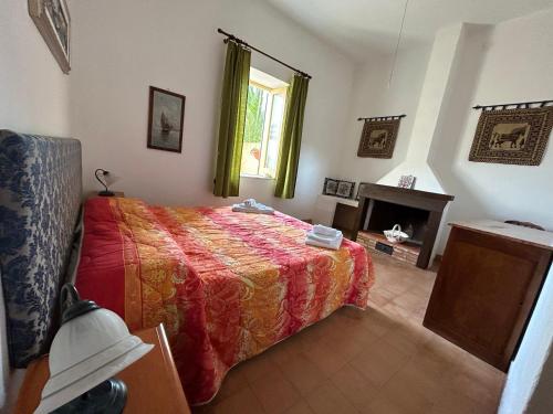a bedroom with a bed and a fireplace at Casale Galati in Sciacca
