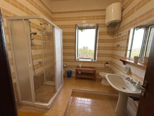 a bathroom with a shower and a toilet and a sink at Casale Galati in Sciacca