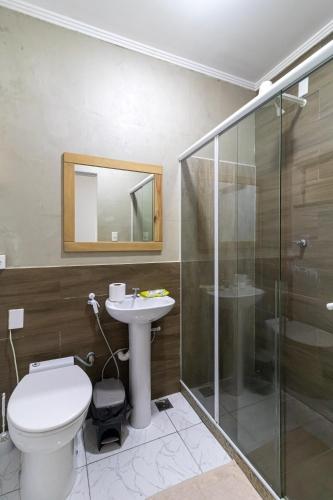 a bathroom with a toilet and a sink and a shower at Maroca RIO in Rio de Janeiro