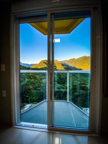 a large window with a view of a tennis court at Hotel Du Rastro in Louro Müller