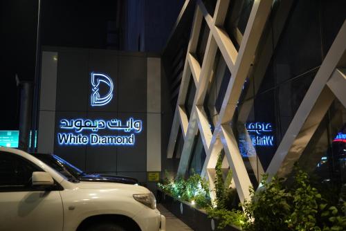 a white car parked in front of a building at White Diamond Hotel Sari in Jeddah