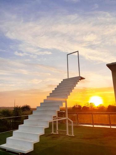 a set of stairs with a sunset in the background at LOHAS Airport Hotel and Restaurant in Cagayan de Oro