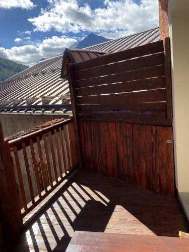 a wooden fence on a balcony with a view at Baita Rousinette in Joussaud