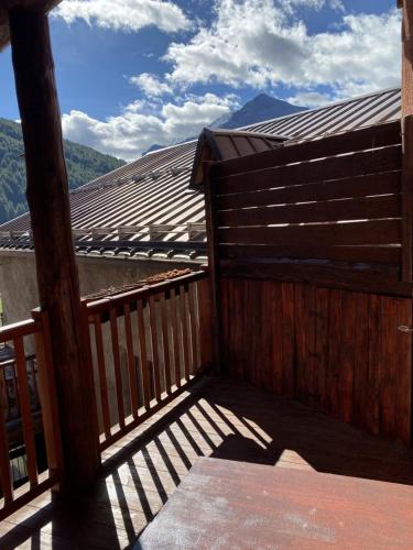 a wooden balcony with a view of a mountain at Baita Rousinette in Joussaud