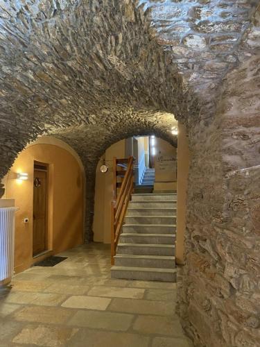 a stone hallway with stairs and a stone wall at Baita Rousinette in Joussaud