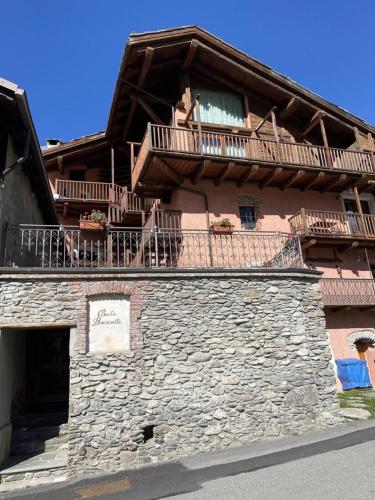 a building with a balcony on top of it at Baita Rousinette in Joussaud