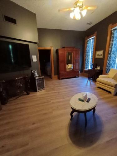 a living room with a couch and a coffee table at Grand Central Hotel in Eureka Springs