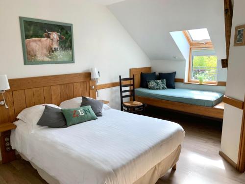 a bedroom with two beds and a cow picture on the wall at La Ferme de Maraval in Cénac-et-Saint-Julien