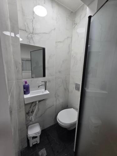 a bathroom with a toilet and a sink and a mirror at Ryo 36 דירת נופש מושלמת מרחק 5 דקות מחוף הים in Bat Yam