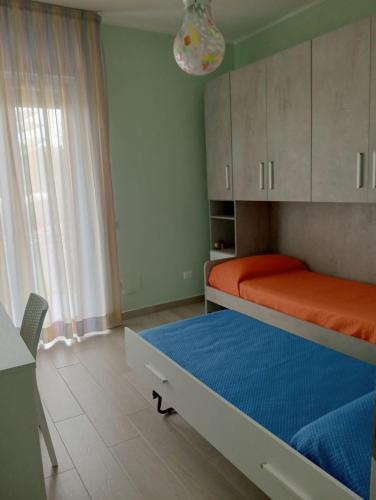 a small room with a bed and a window at Luli Holidays Paestum in Paestum