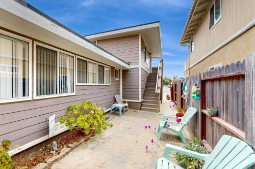 a patio with two chairs and a house at Sailaway Cabin in Ventura