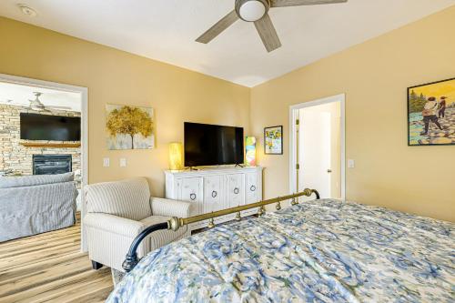 a bedroom with a bed and a tv and a chair at Keowee Key Condo with Lake Access! in Salem