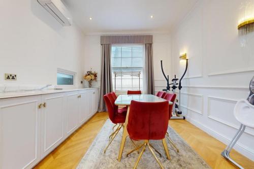 a kitchen with a table and red chairs at -Air Con- Premium House - Prime location in London