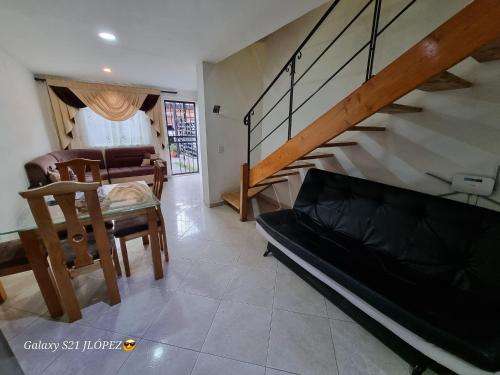 a living room with a couch and a staircase at La Casa Perfecta para Grupos en el Centro in Rionegro