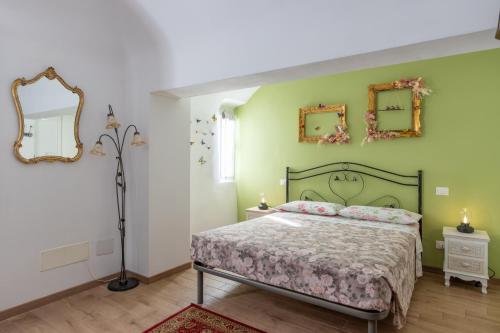 a bedroom with a bed and two mirrors on the wall at Chrizia in Novi Ligure