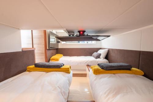 a room with three beds in it with a room with at 2BR Heated Yacht, Lymington Centre, Beautiful View in Lymington