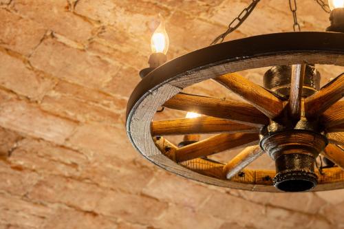 a wooden chandelier hanging from a brick wall at Chrizia in Novi Ligure