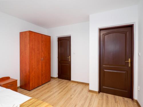 an empty bedroom with two doors and wooden floors at Giewont in Murzasichle