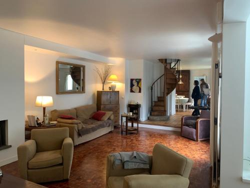 un salon avec un canapé et des chaises dans l'établissement Maison de campagne à Paris, à Paris