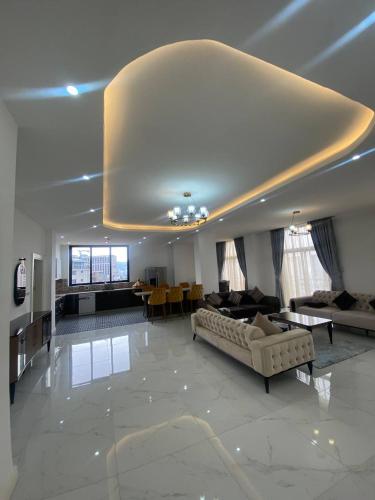 a large living room with a couch and a table at Zemilo Hotel Apartment in Addis Ababa