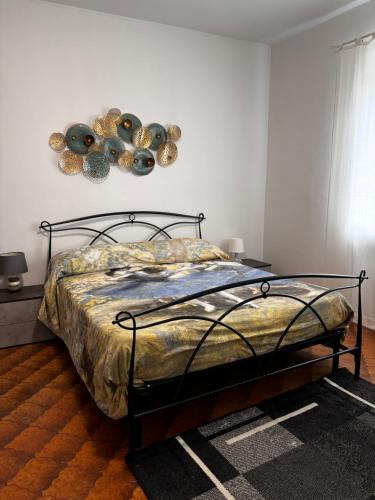 a bedroom with a bed with a metal frame at Casa Teresa in Murazzano