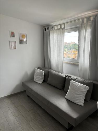 a couch in a living room with a window at Veio Terrace in Rome