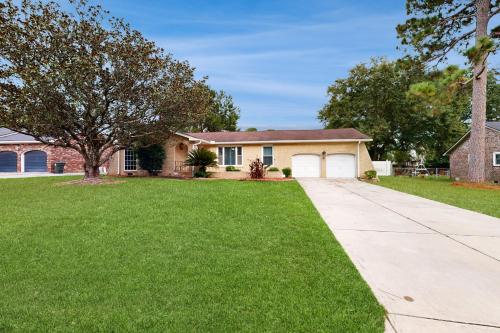 a house with a tree and a driveway at Bring Your Pup! Goose Creek Home with Private Pool in Charleston