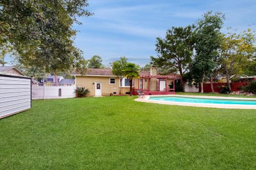a house with a yard with a swimming pool at Bring Your Pup! Goose Creek Home with Private Pool in Charleston