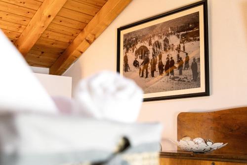 a picture on the wall of a room with a table at B&B Antico Borgo Marcemigo in Tregnago