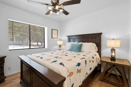 a bedroom with a bed and a ceiling fan at Woodland Escape - Quiet Area, Walk to Hiking Trails & Park! in Big Bear City