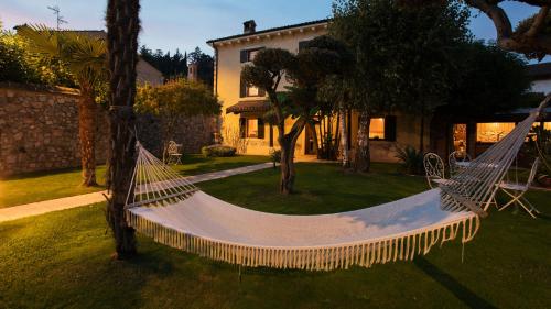 a hammock in the yard of a house at B&B Antico Borgo Marcemigo in Tregnago