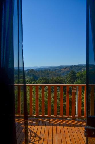 a view from the balcony of a house at Chalés Laraland in Campos do Jordão