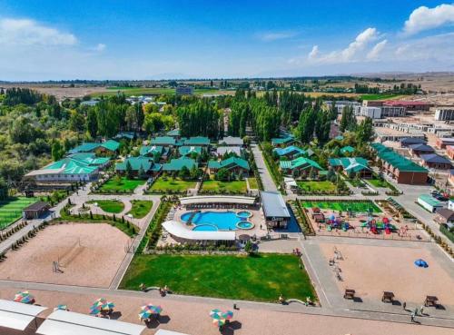 an aerial view of a resort with a pool and beach at Raduga West 'Pearl' Apartment in Koshkolʼ