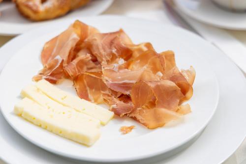 a plate of food with cheese and meat on it at B&B Antico Borgo Marcemigo in Tregnago