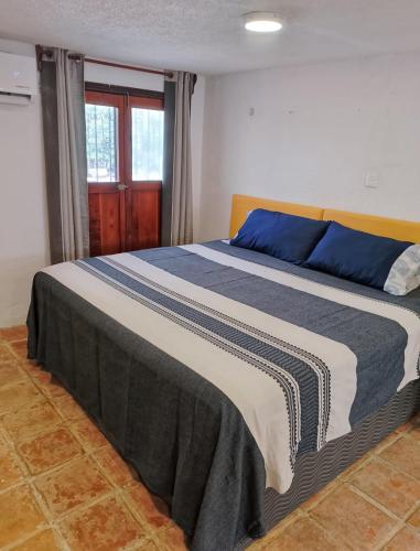 a bedroom with a large bed with blue and white sheets at Casa Nance Alojamientos UXMAL Suite Ejecutiva Centro Mercado 28 y ADO King Size in Cancún