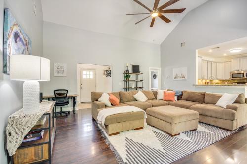 a living room with a couch and a table at Less Than 1 Mi to Beach - Home with Deck and Yard in Waveland! in Waveland