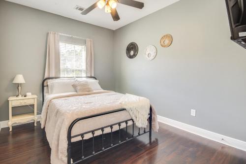 a bedroom with a bed and two clocks on the wall at Less Than 1 Mi to Beach - Home with Deck and Yard in Waveland! in Waveland