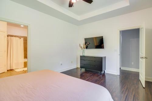 a white bedroom with a bed and a dresser at Less Than 1 Mi to Beach - Home with Deck and Yard in Waveland! in Waveland