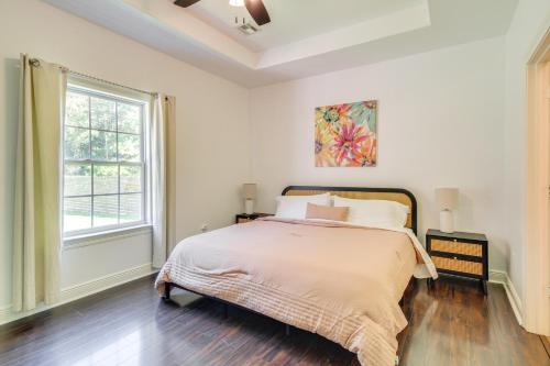 a white bedroom with a bed and a window at Less Than 1 Mi to Beach - Home with Deck and Yard in Waveland! in Waveland