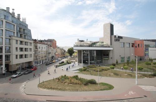 a city street with buildings and people walking on the street at "Deluxe Apartments" K 44 - 1225 in Lviv