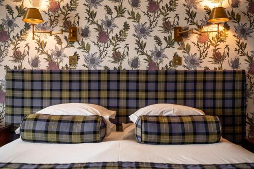 a bedroom with two beds with a plaid headboard at Bunchrew House Hotel in Inverness