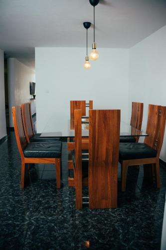 a dining room with a table and four chairs at Residenciales H1 & H2 - Breakfast & Room Service - Airport close in Santiago de los Caballeros