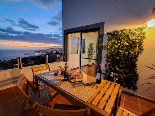 a dining room with a table and a view of the ocean at Funchal Sunset Apartment in Funchal
