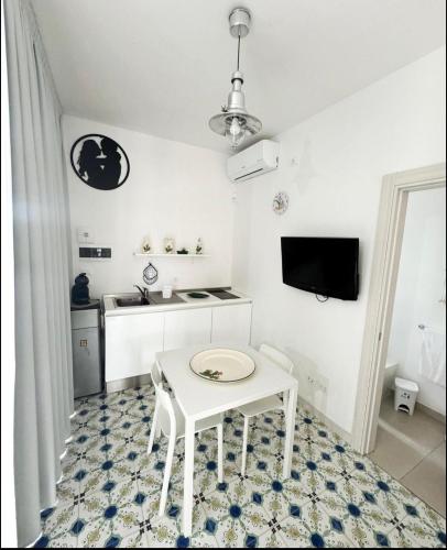 a white table and chair in a white room at Vento del Mar Tramontana in San Cataldo