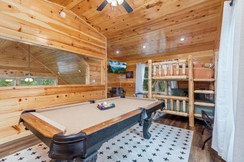 a game room with a pool table in a log cabin at Fully Loaded Cabin In Heart Of Pigeon Forge in Pigeon Forge