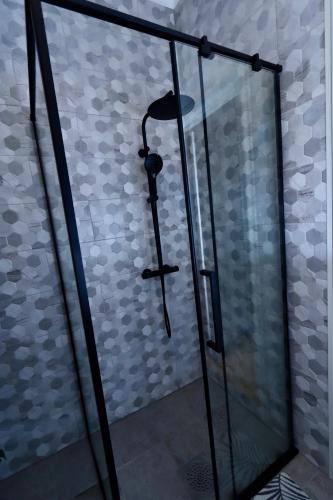 a shower in a bathroom with a glass door at Paidestay apartment with balcony in Paide