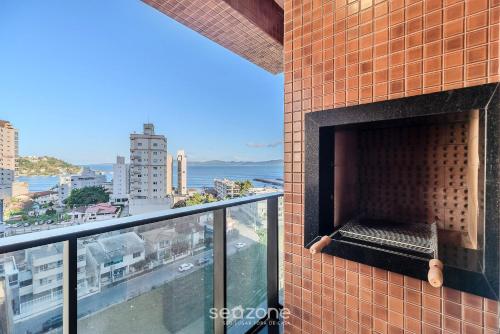 a brick wall with a fireplace on a balcony at MHF II - Apts Variados em Prédio com Vista para o Mar em Itapema in Itapema