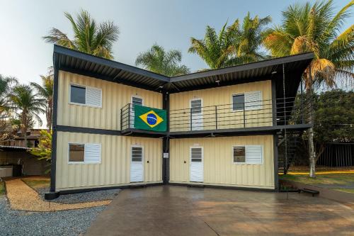 a building with a balcony with a flag on it at Flat Studio Alto Padrão em Patos de Minas in Patos de Minas